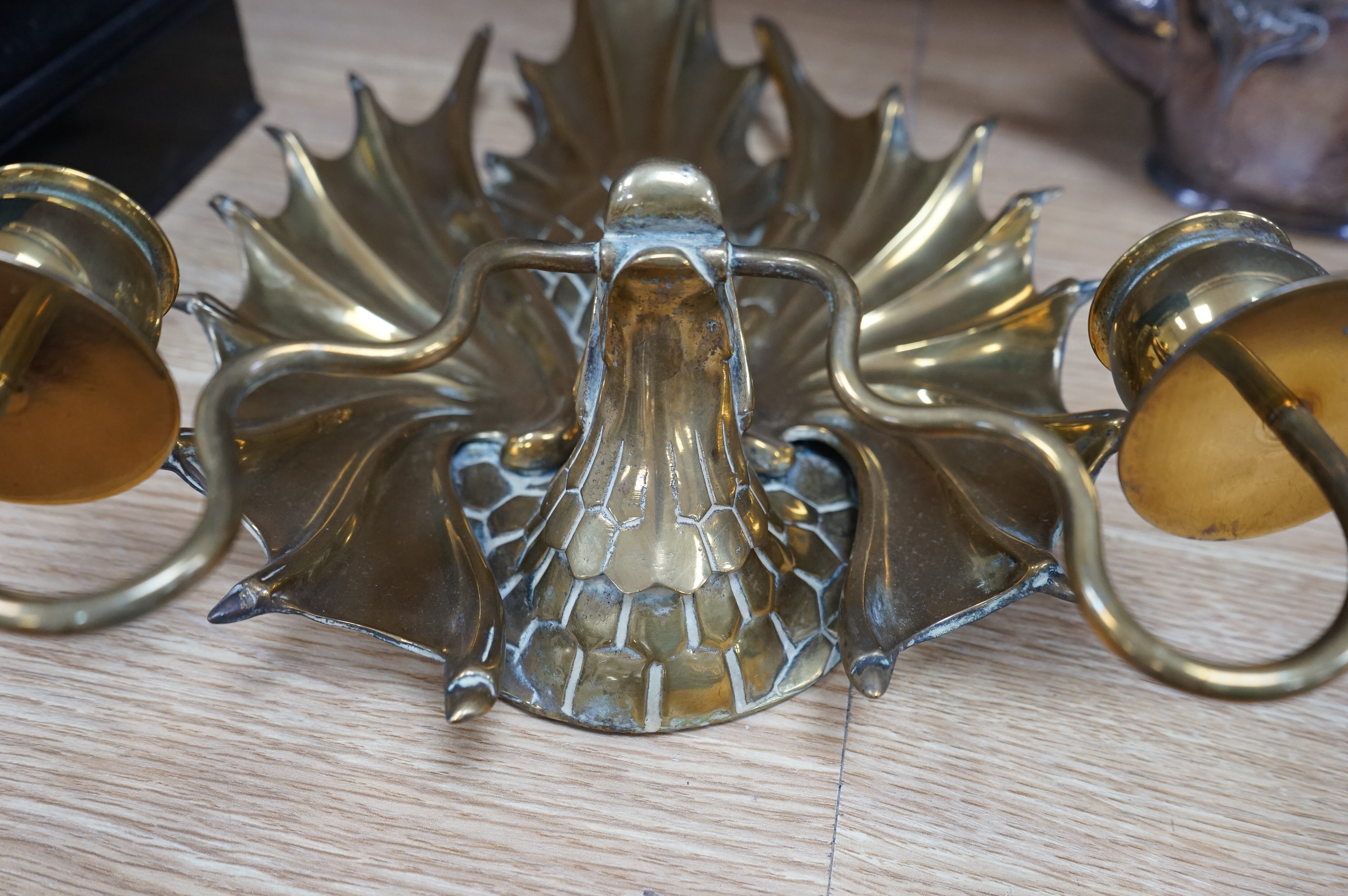 A brass two branch stylised dragon wall sconce, 36cm high. Condition - good